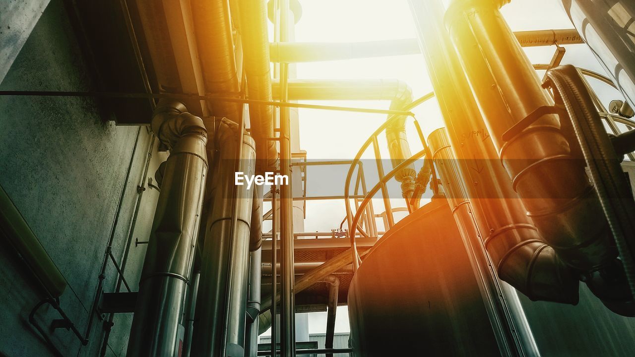 Low angle view of metal structure against sky during sunset