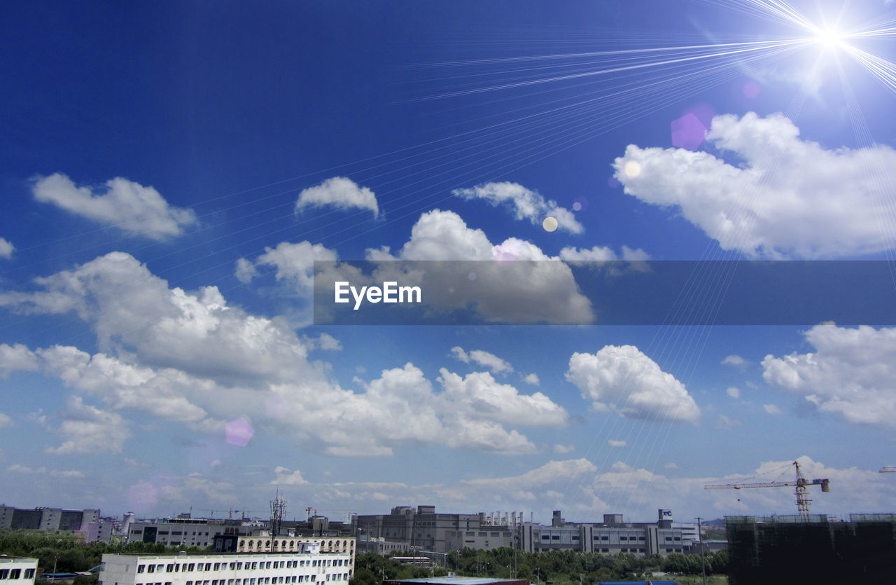 LOW ANGLE VIEW OF BUILDINGS AGAINST BLUE SKY