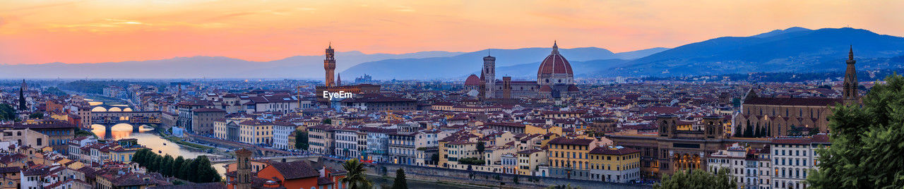 high angle view of city against sky during sunset