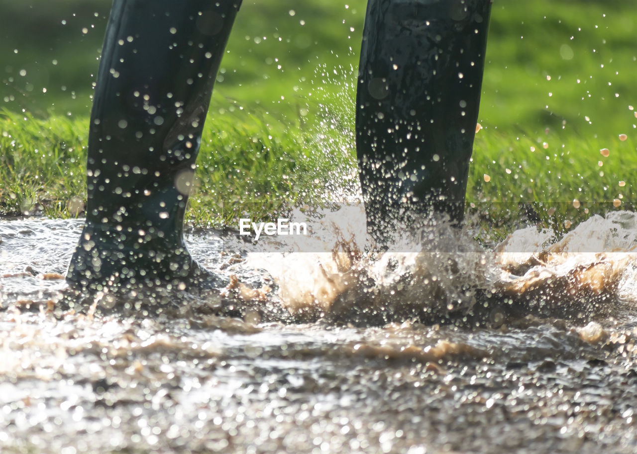 Low section of person splashing water