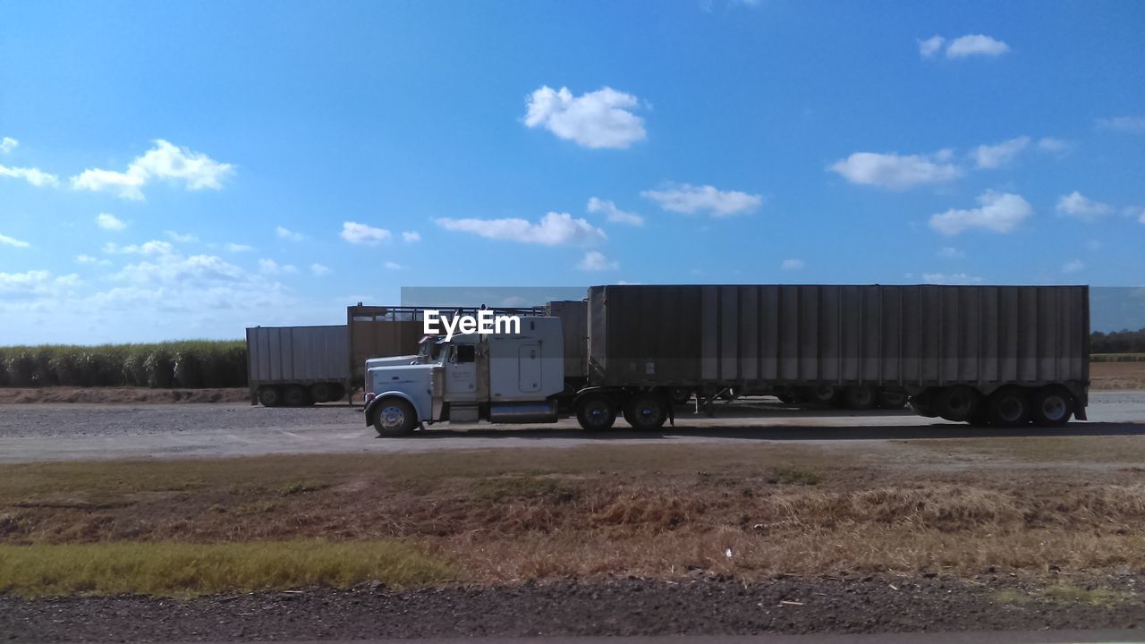 Truck on farm against sky