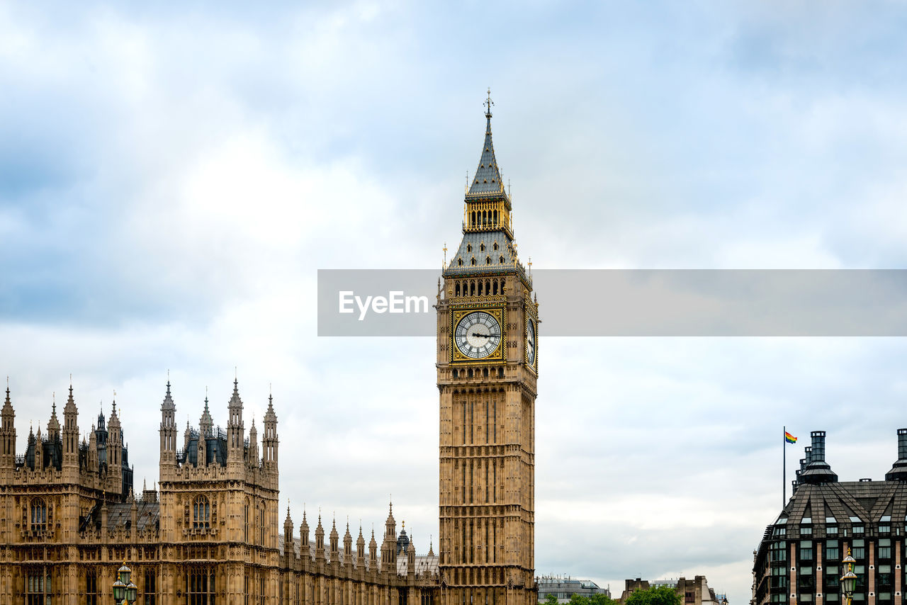 Low angle view of big ben in city against cloudy sky