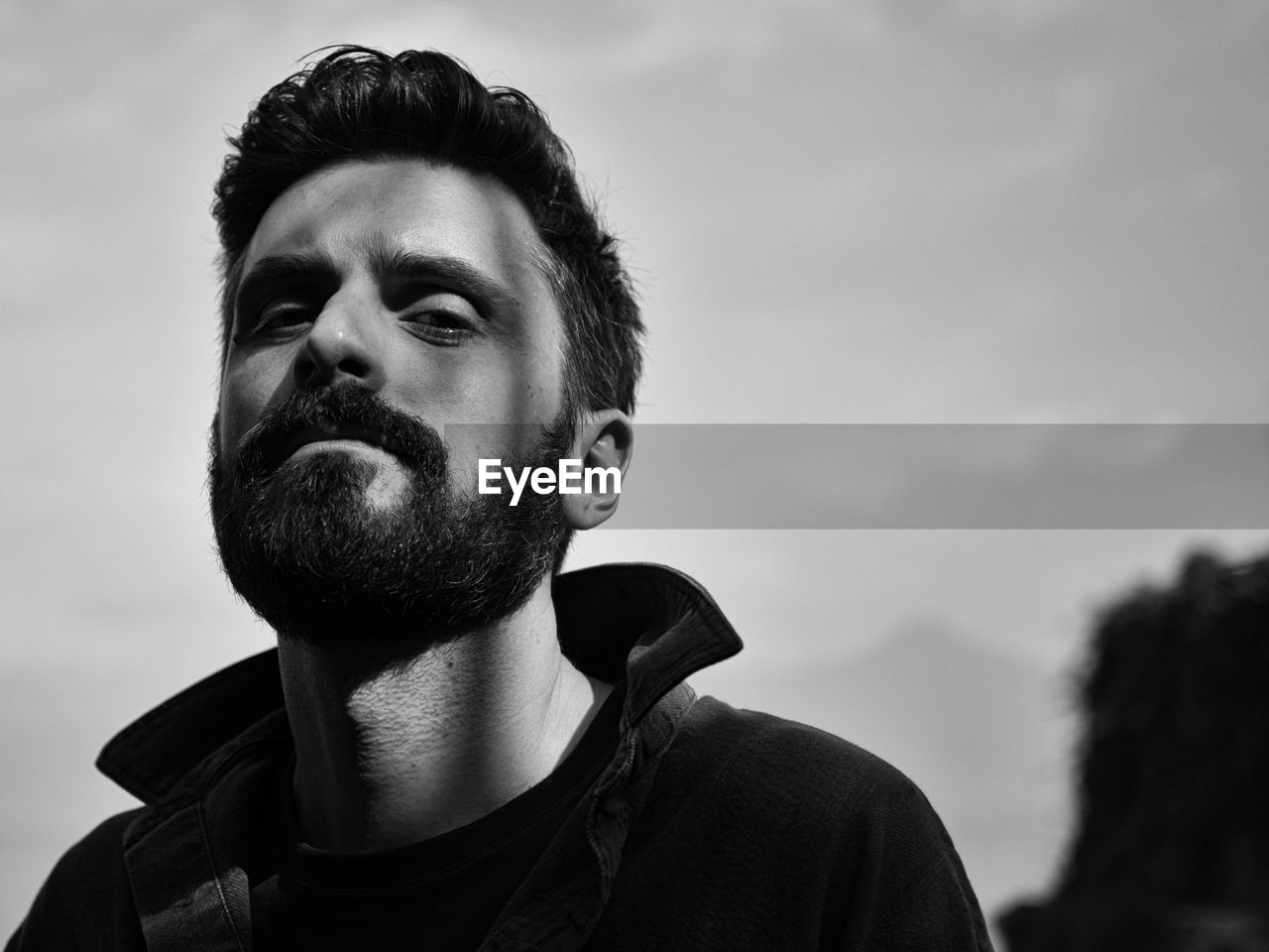 Close-up portrait of man against sky