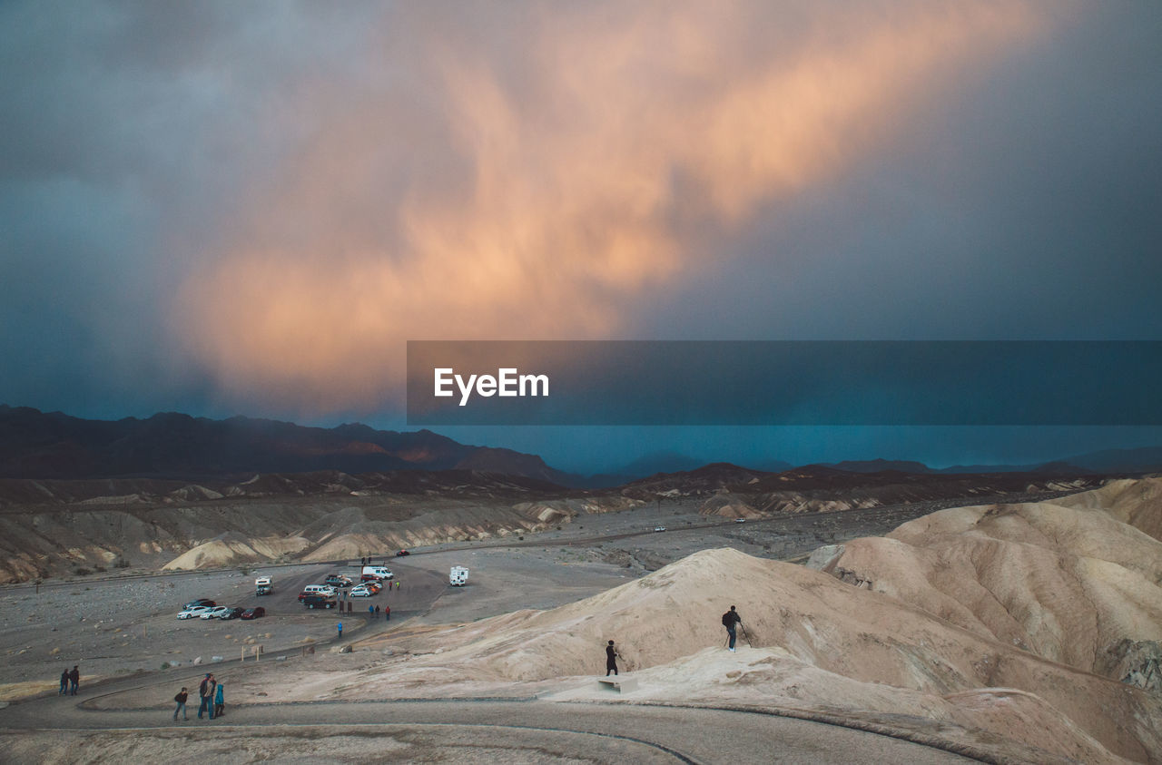 High angle view of people hiking at death valley national park against cloudy sky