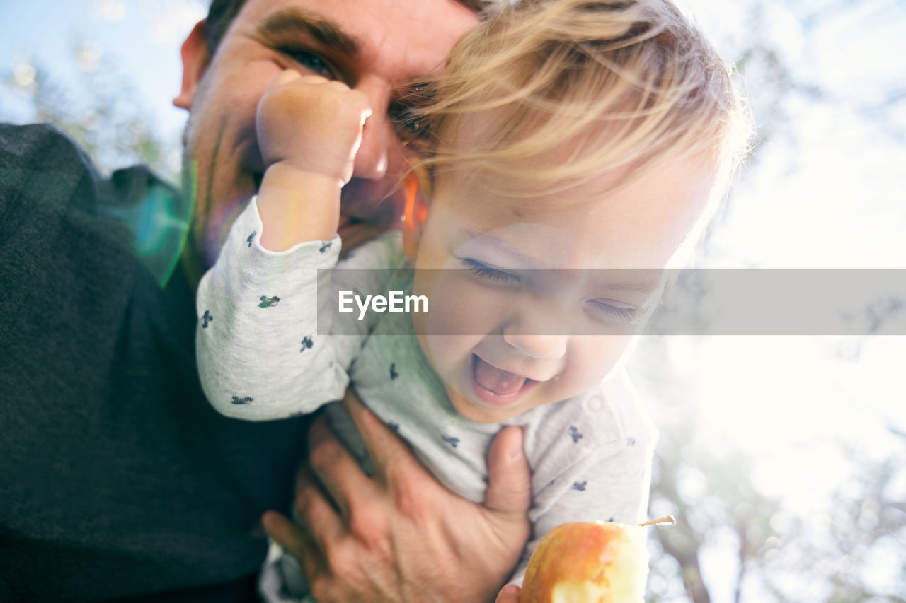 Father playing with daughter outdoors