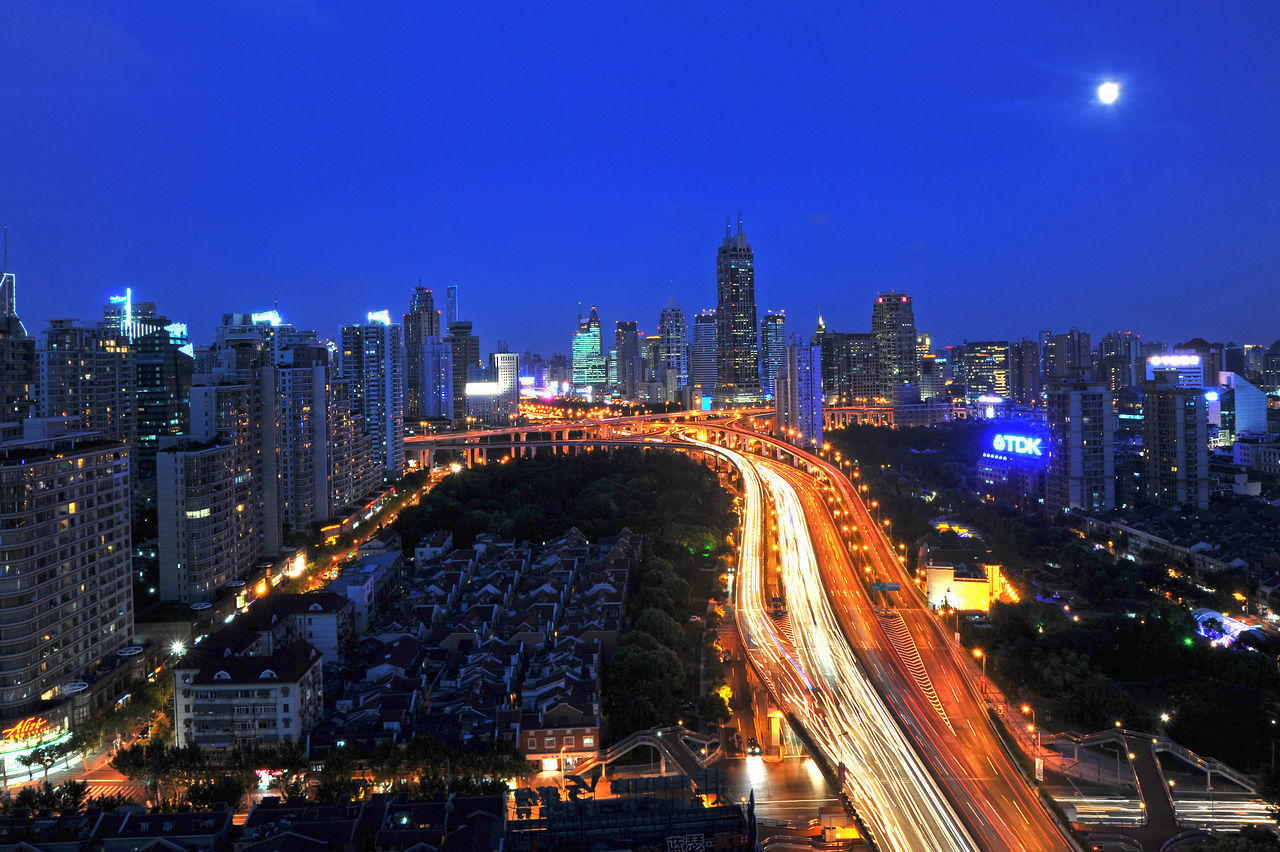 HIGH ANGLE VIEW OF ILLUMINATED CITY AT NIGHT
