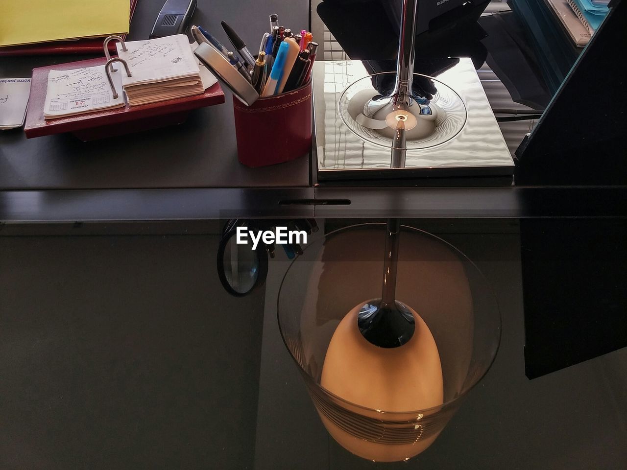 Reflection of illuminated lamp on glass table