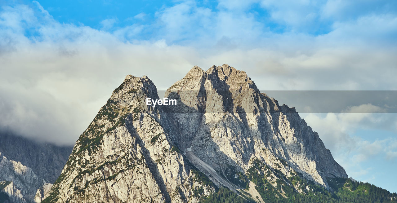 Low angle view of snowcapped mountain against sky