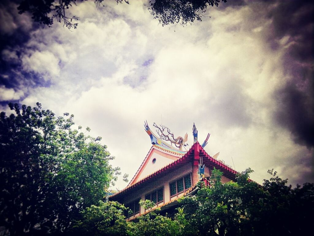 LOW ANGLE VIEW OF TEMPLE AGAINST CLOUDY SKY