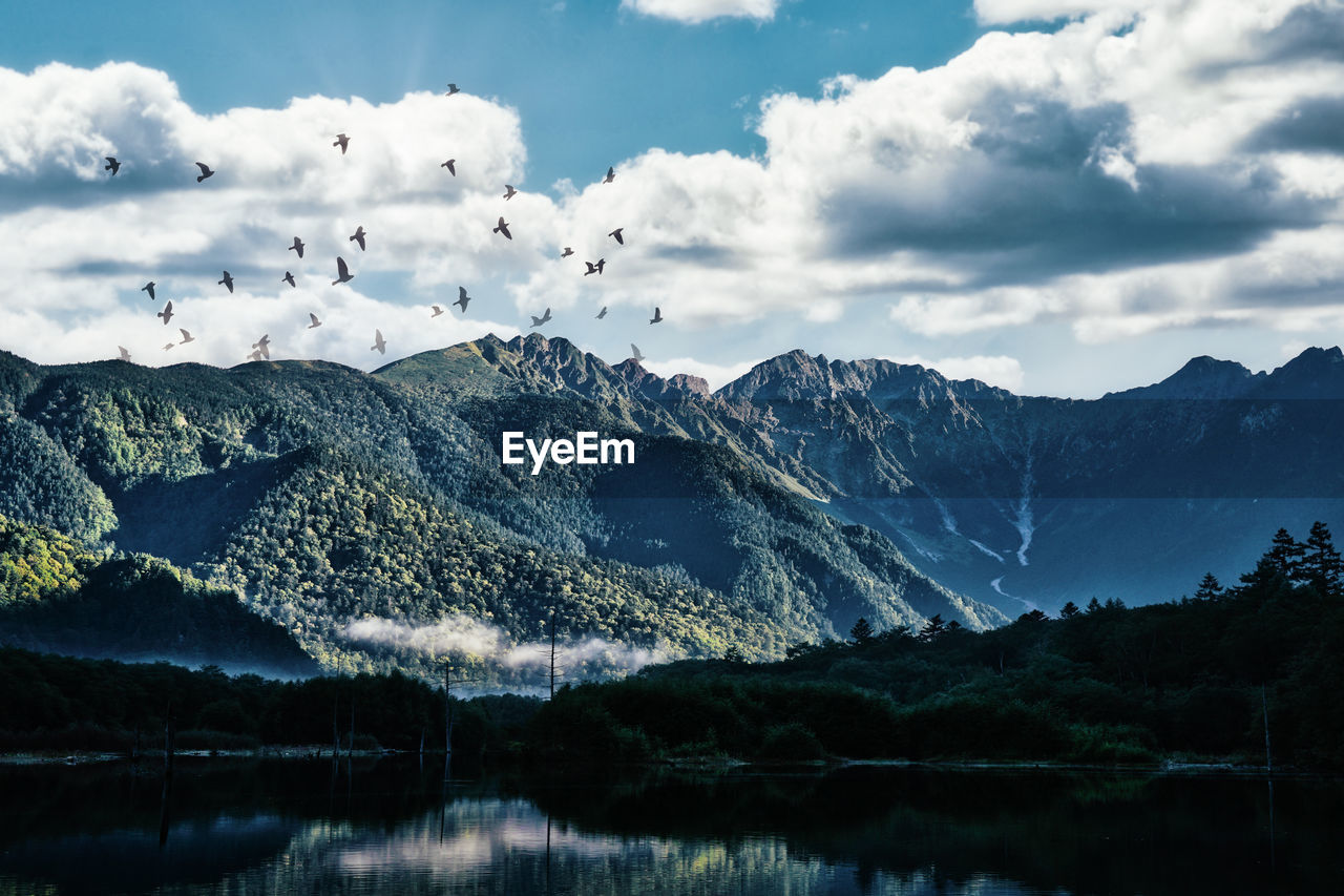 Scenic view of lake and mountains against sky