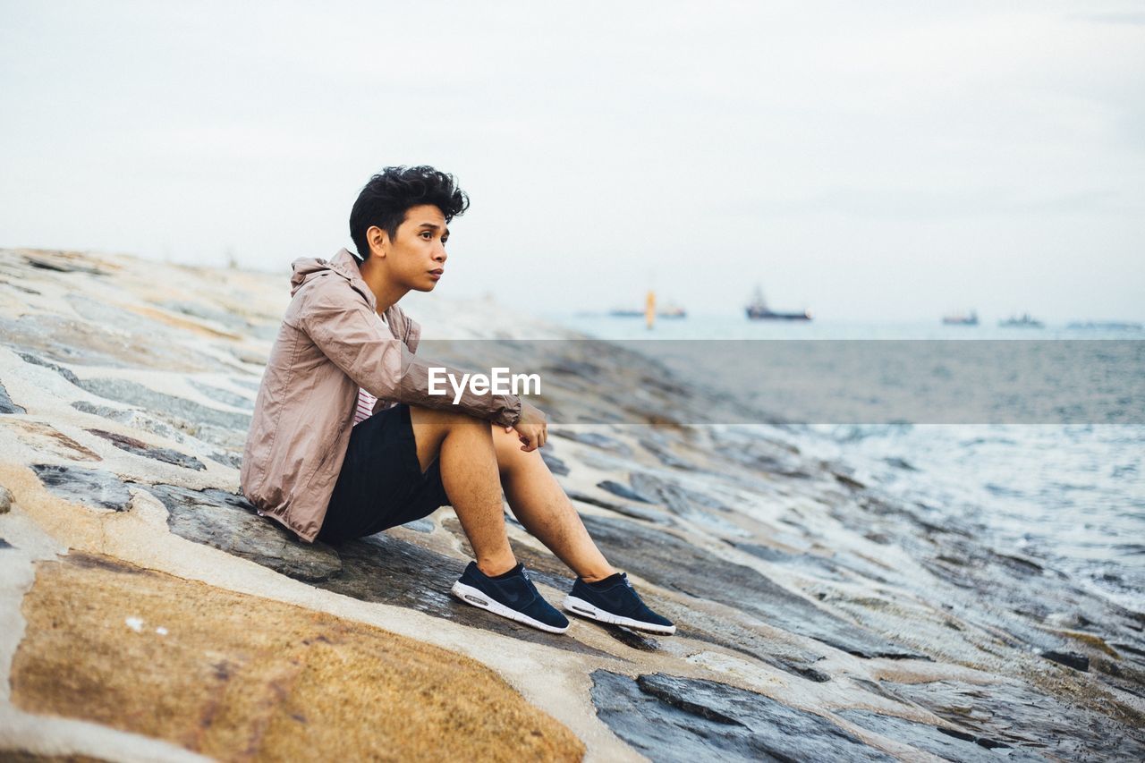 WOMAN STANDING ON SHORE