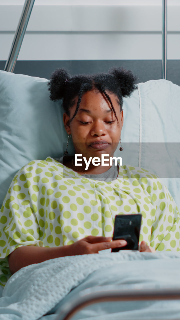 Female patient talking on video call at hospital ward