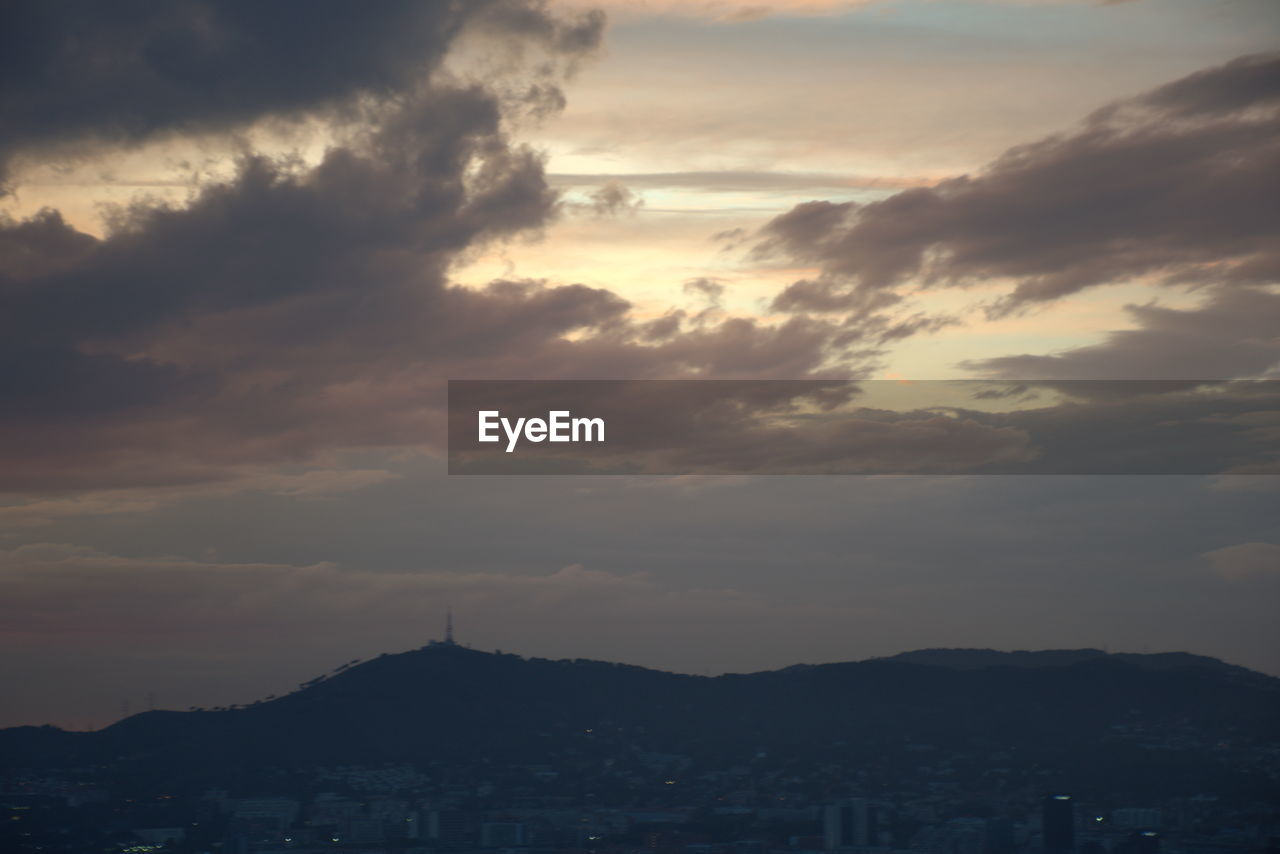 SCENIC VIEW OF CITY AGAINST DRAMATIC SKY