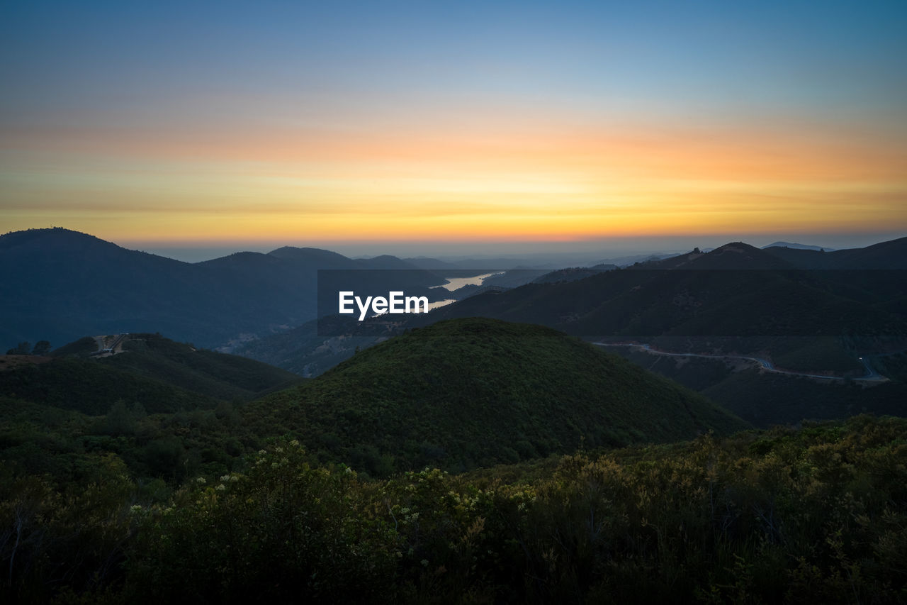 SCENIC VIEW OF MOUNTAIN AGAINST SKY DURING SUNSET