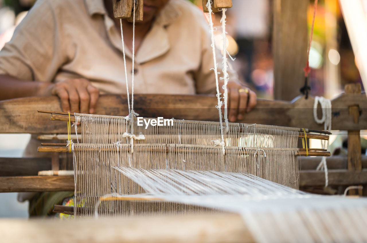 Midsection of manual worker working in textile industry