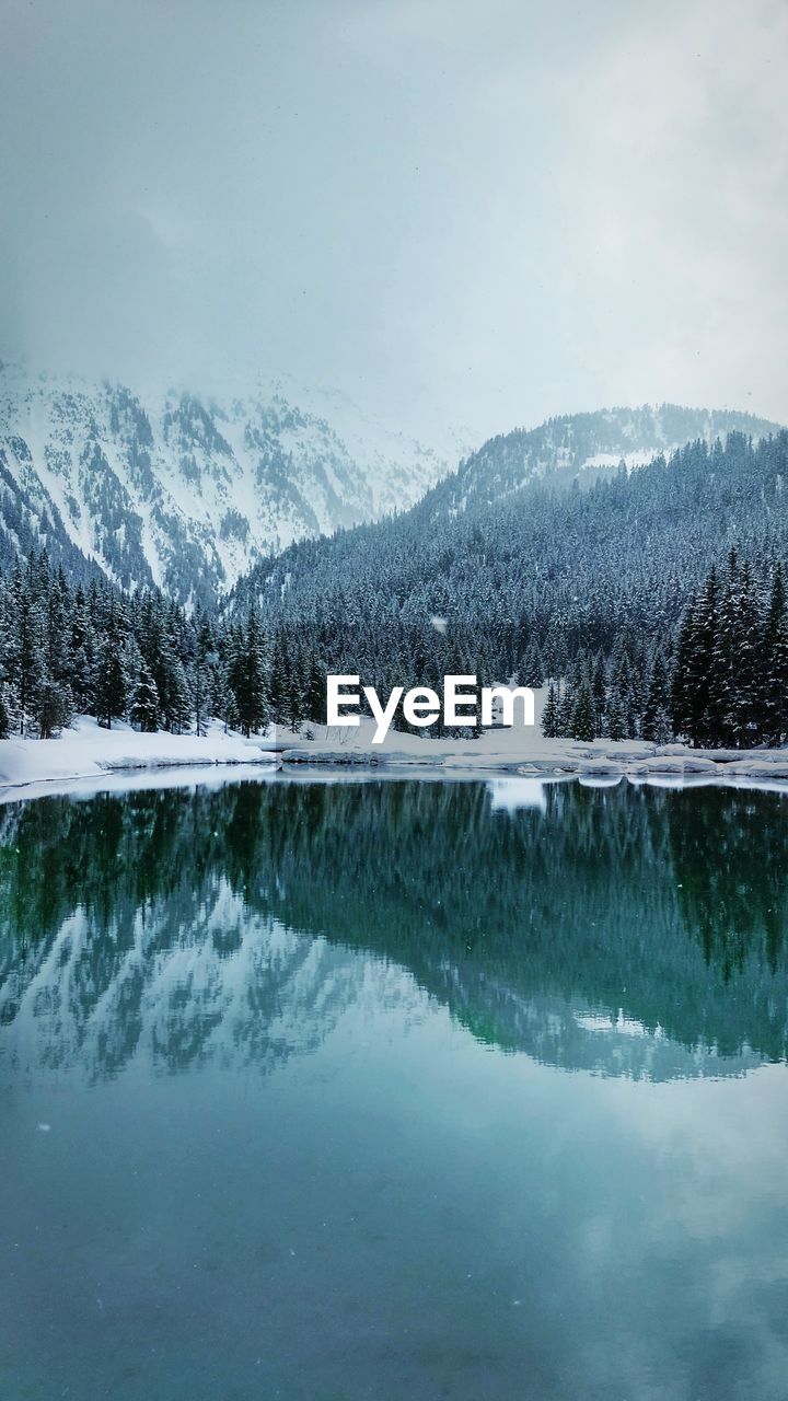 Reflection of mountains in lake during winter
