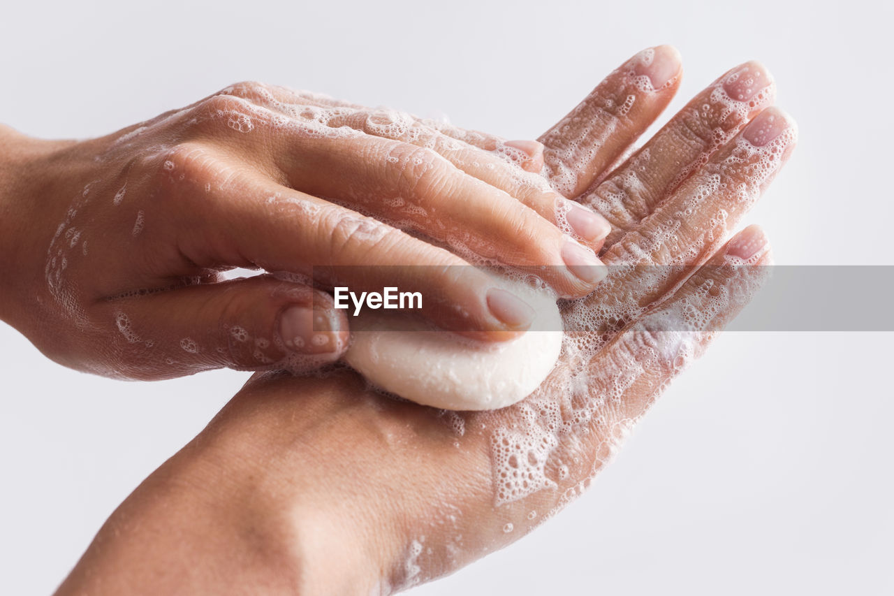 Cropped image of woman cleaning hand with soap