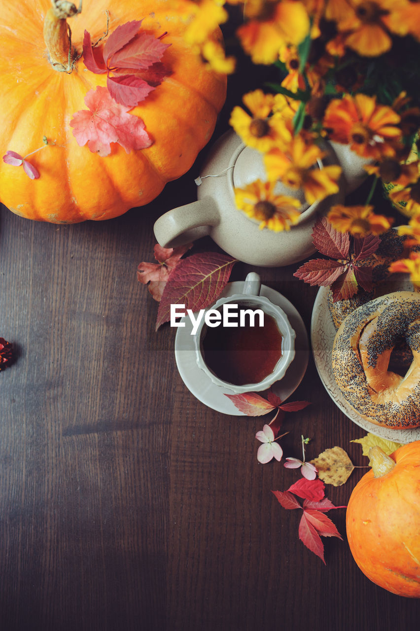 High angle view of pumpkins and coffee on table