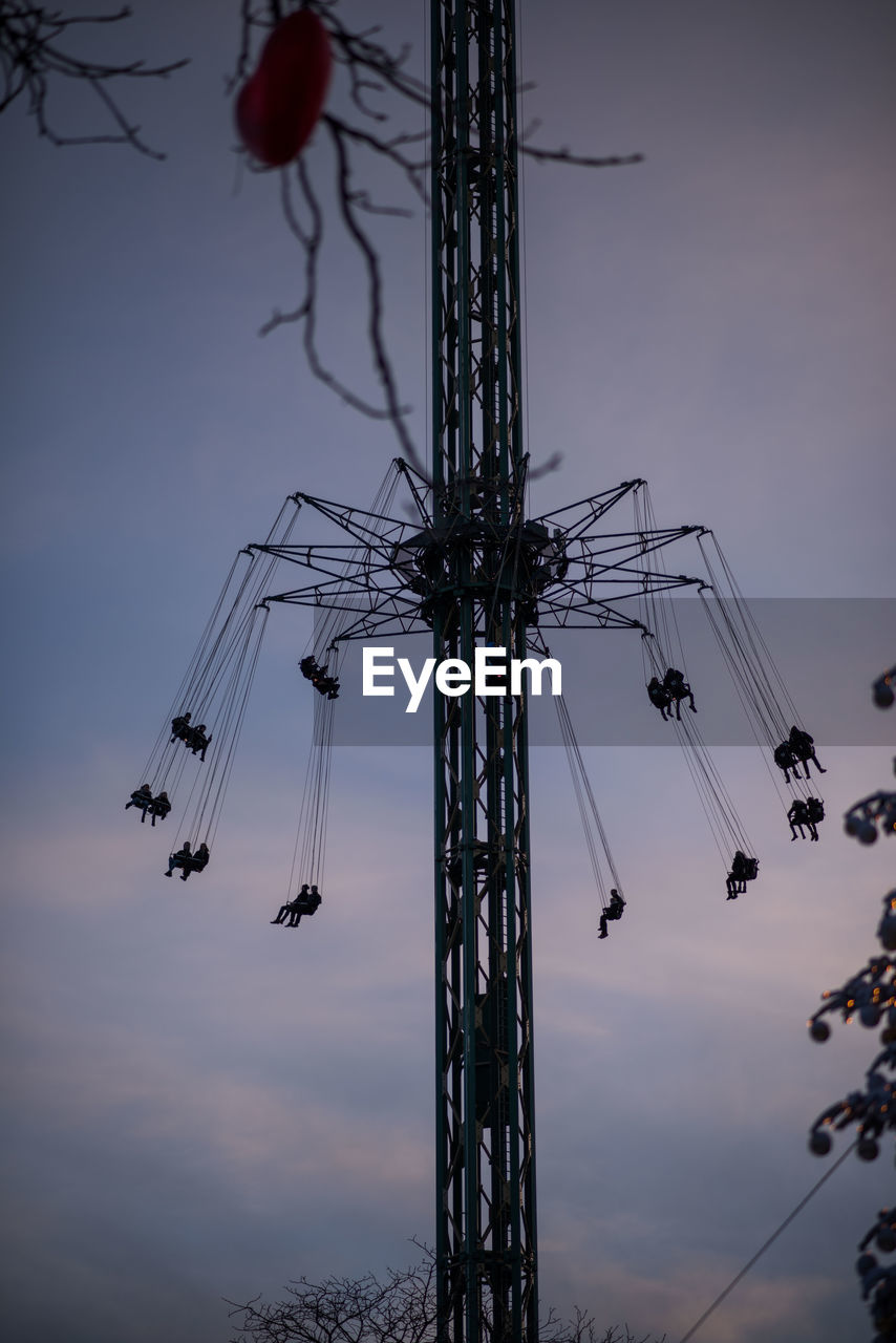 LOW ANGLE VIEW OF AMUSEMENT RIDE AGAINST SKY