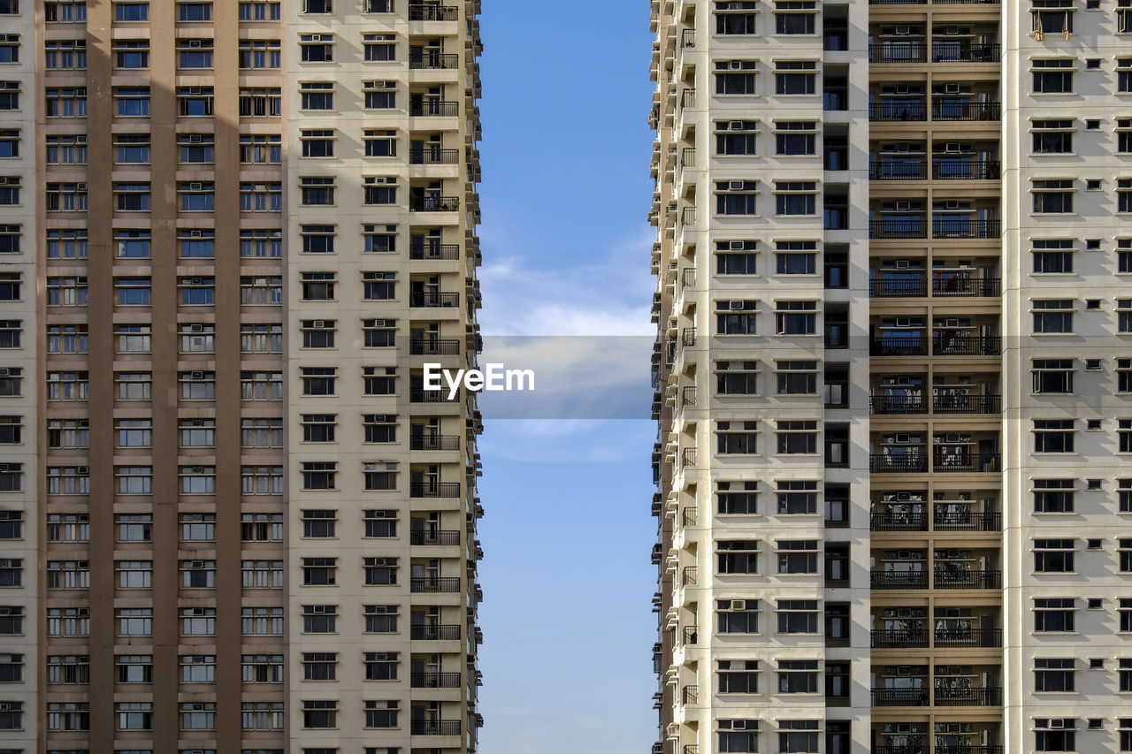 Low angle view of buildings in city against sky