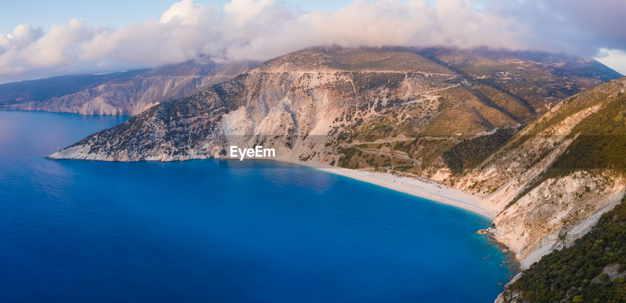 AERIAL VIEW OF SEA AND MOUNTAIN AGAINST SKY