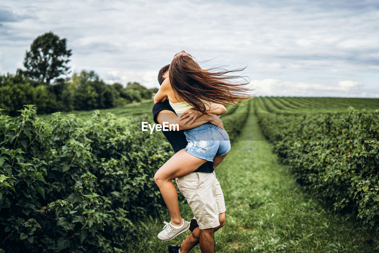 Young couple have fun on plant in land