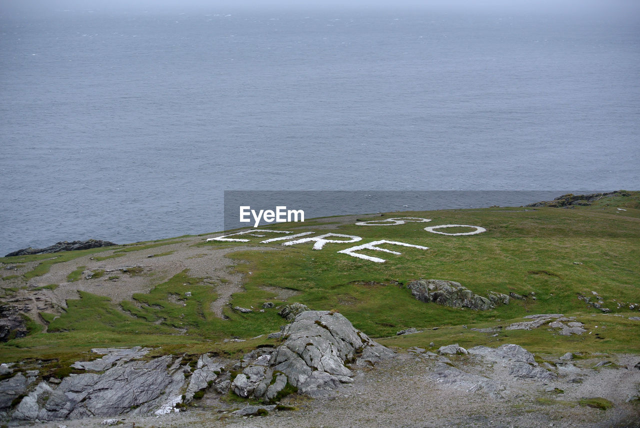 High angle view of rocks on sea shore