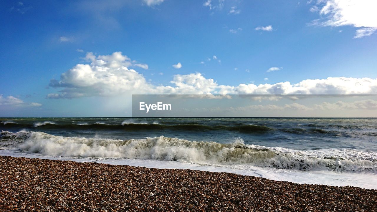 SCENIC VIEW OF SEA SHORE AGAINST SKY