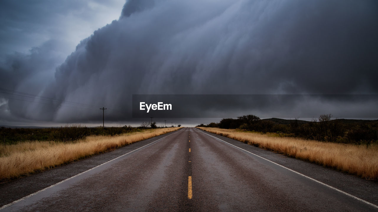 Empty road along countryside landscape