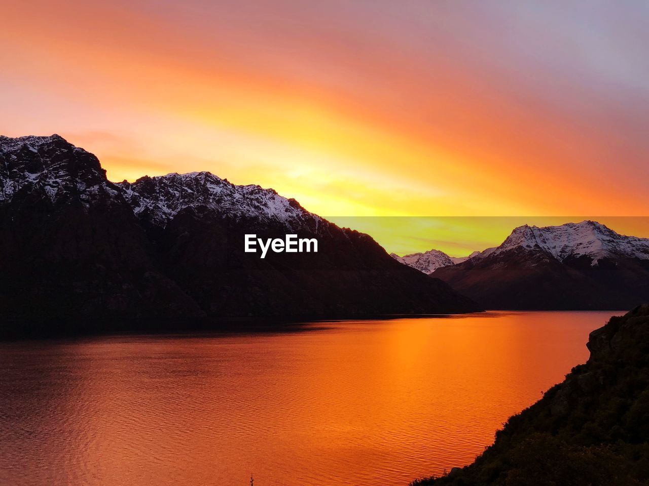 SCENIC VIEW OF LAKE DURING SUNSET