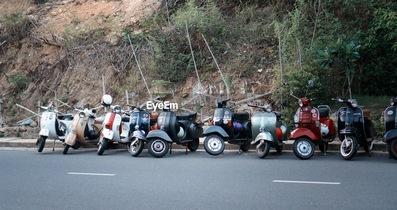 Motor scooters parked on road