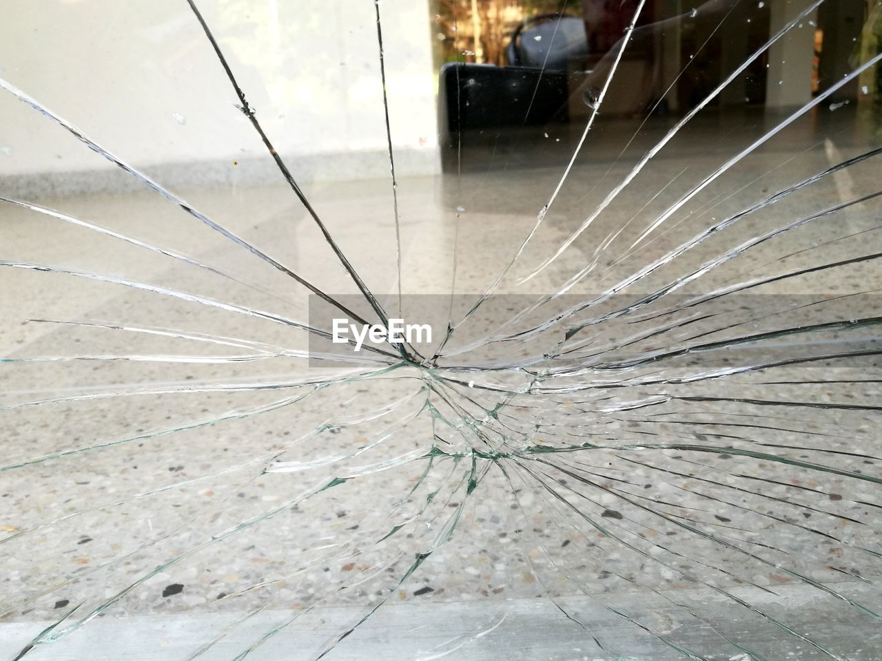 CLOSE-UP OF DAMAGED WINDOW IN SUNLIGHT