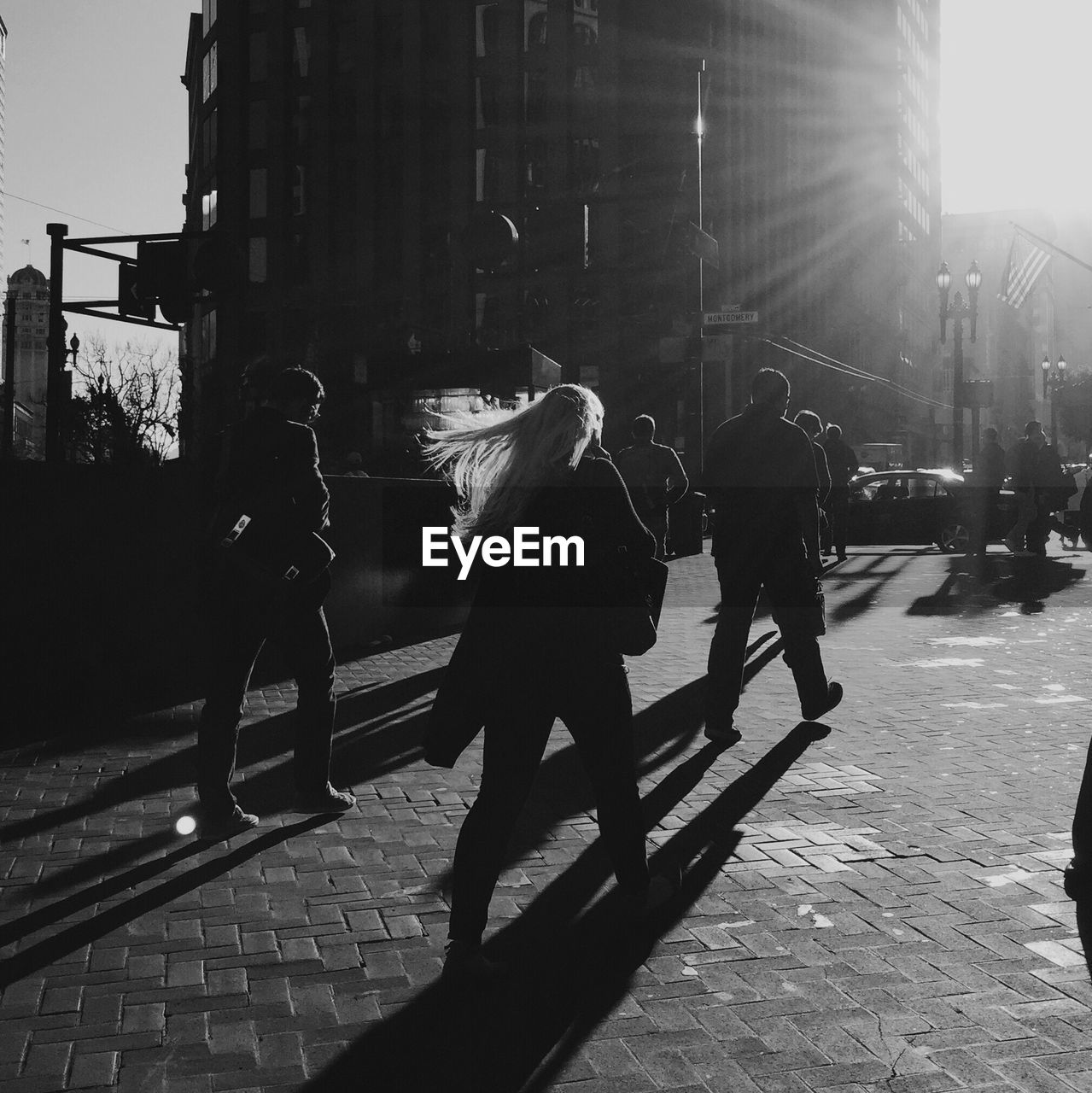 SILHOUETTE OF WOMAN WALKING ON CITY STREET