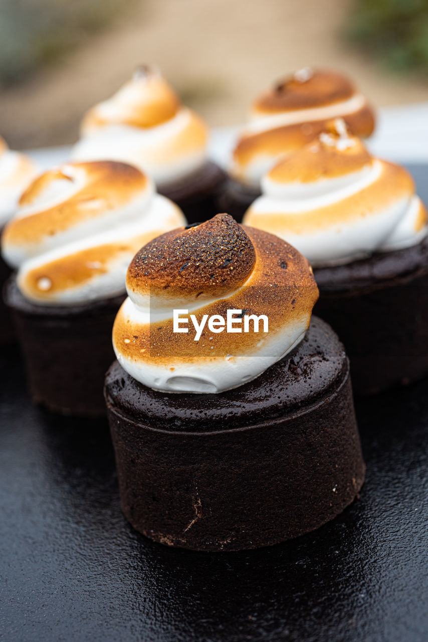 Toasted marshmallow meringue swirls on top of  s'mores baked chocolate brownie cakes dessert snacks