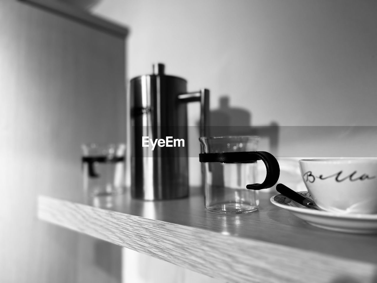 indoors, black and white, food and drink, cup, mug, table, coffee cup, room, drink, no people, monochrome, coffee, household equipment, monochrome photography, domestic room, home interior, tap, still life photography, refreshment, home, still life, white, small appliance, tableware, close-up, domestic life, kitchen, selective focus, domestic kitchen, kitchen utensil, coffeemaker, crockery