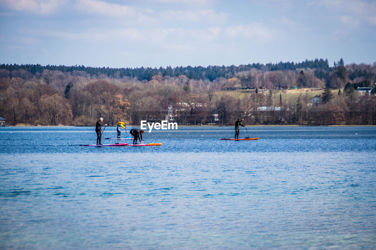 PEOPLE ON RIVER AGAINST SKY