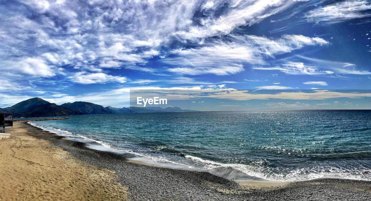 Scenic view of beach against blue sky