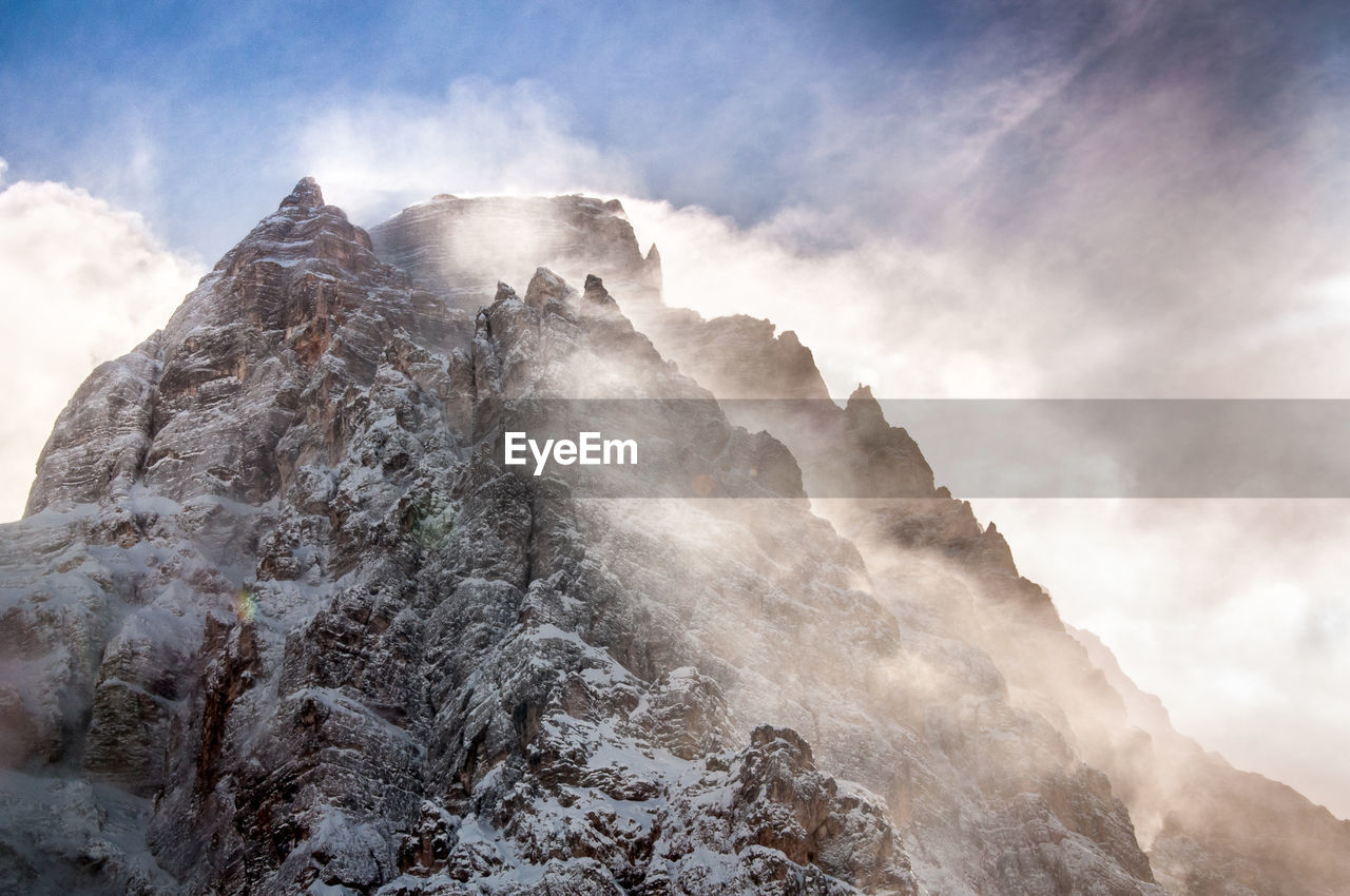 Low angle view of rock formation against sky