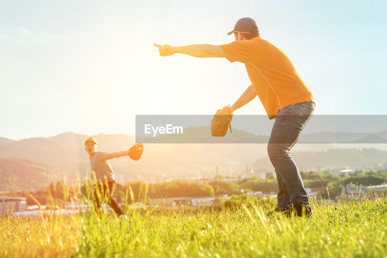 Father and son playing in baseball. man teaching boy baseballs exercise. family sports father's day.