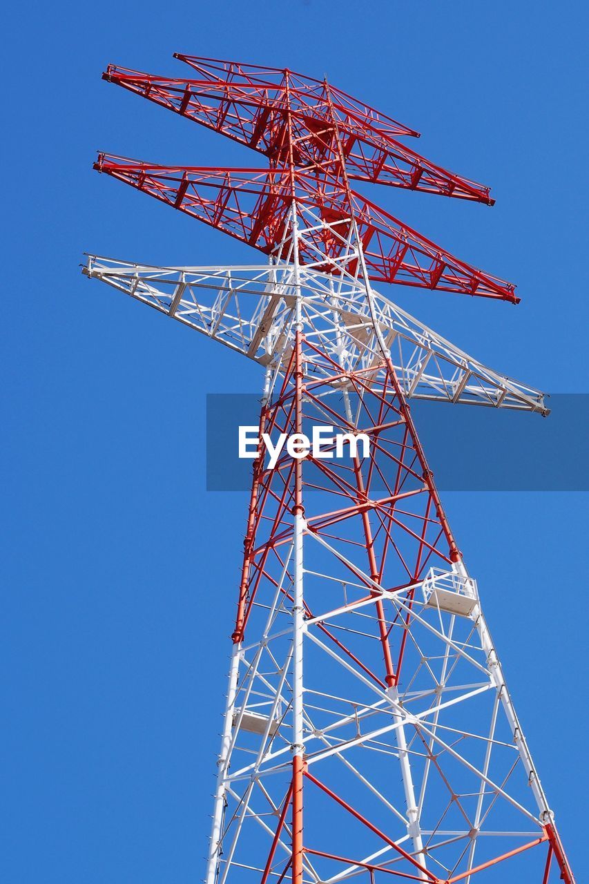 Low angle view of electricity pylon against clear sky