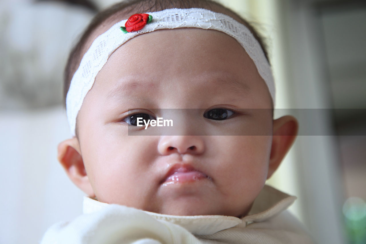 Close-up portrait of baby girl wearing headband
