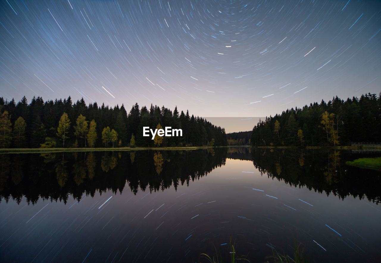 Scenic view of lake against sky at night