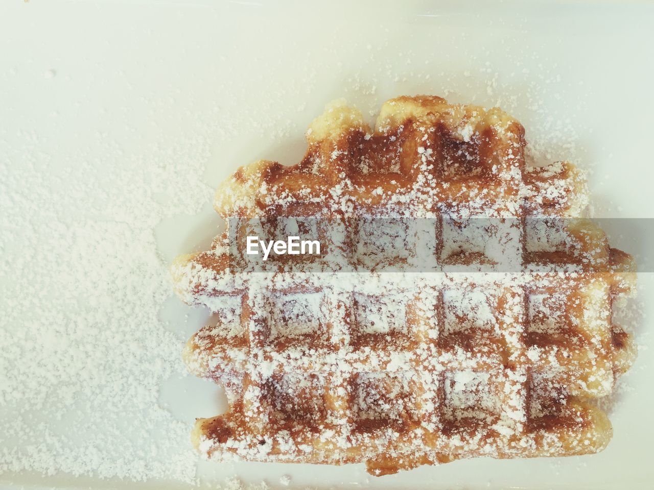 Directly above shot of waffle with powdered sugar