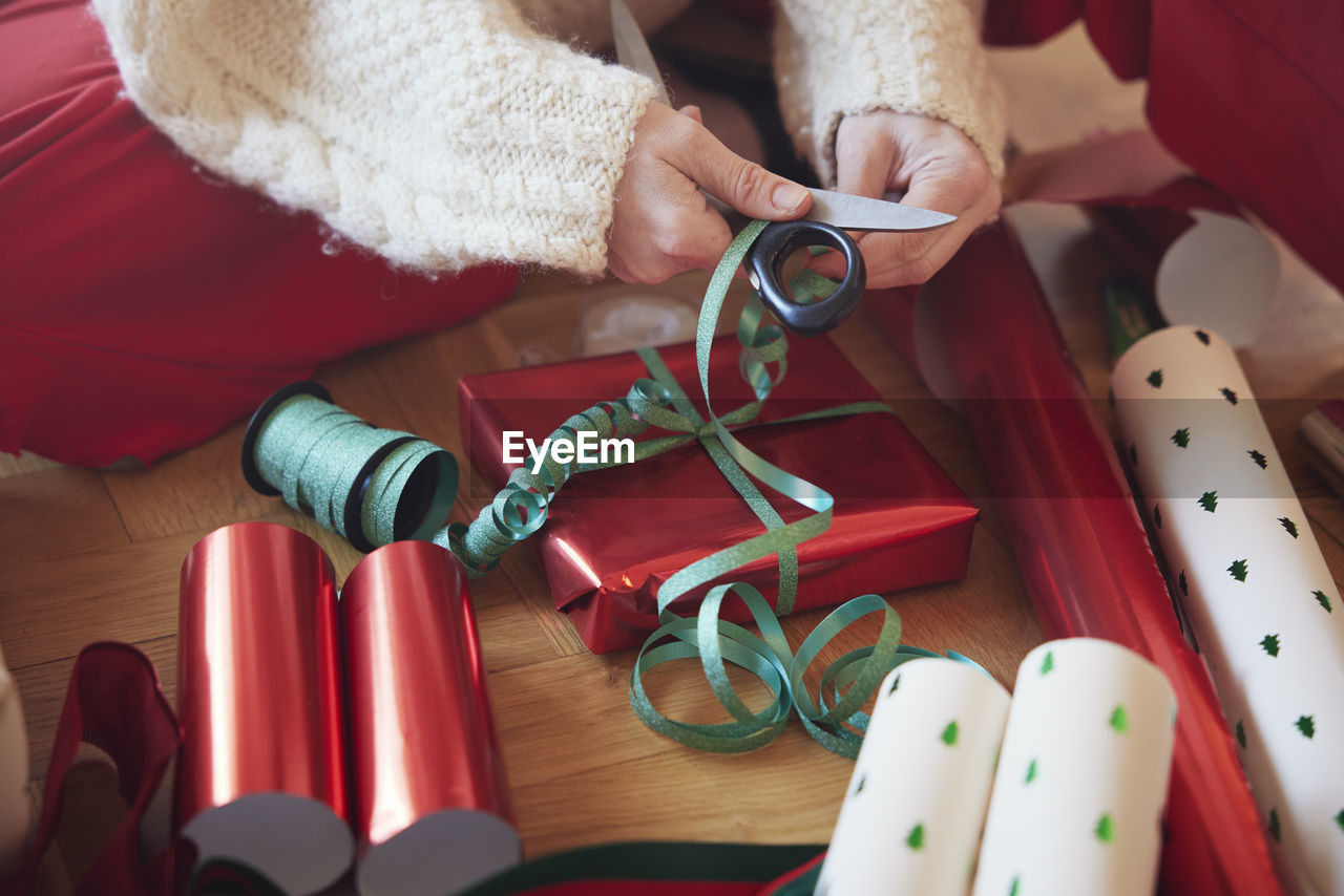 Woman's hands packing christmas presents