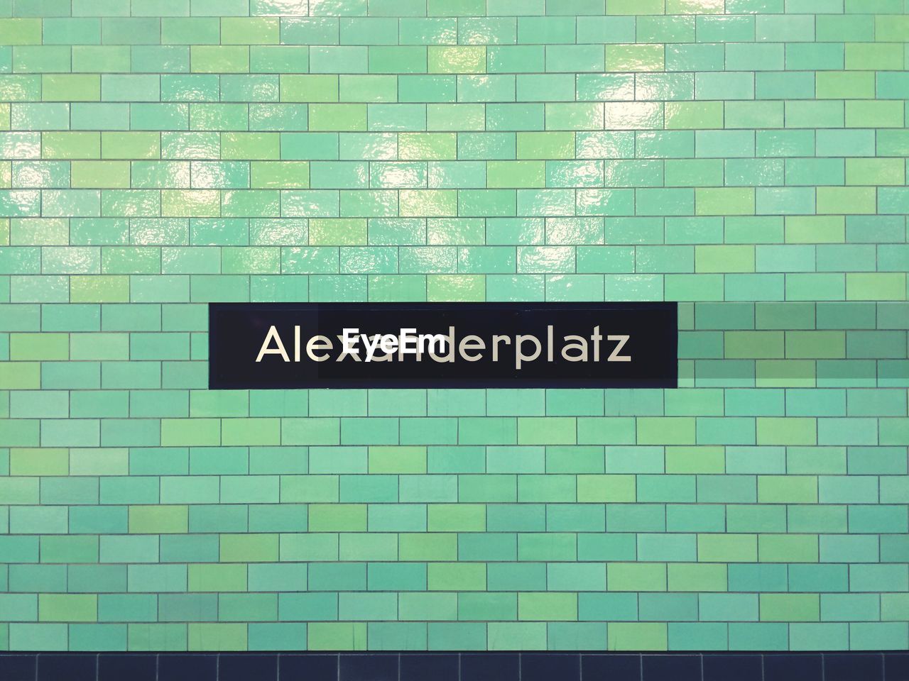 Alexanderplatz sign on wall at subway