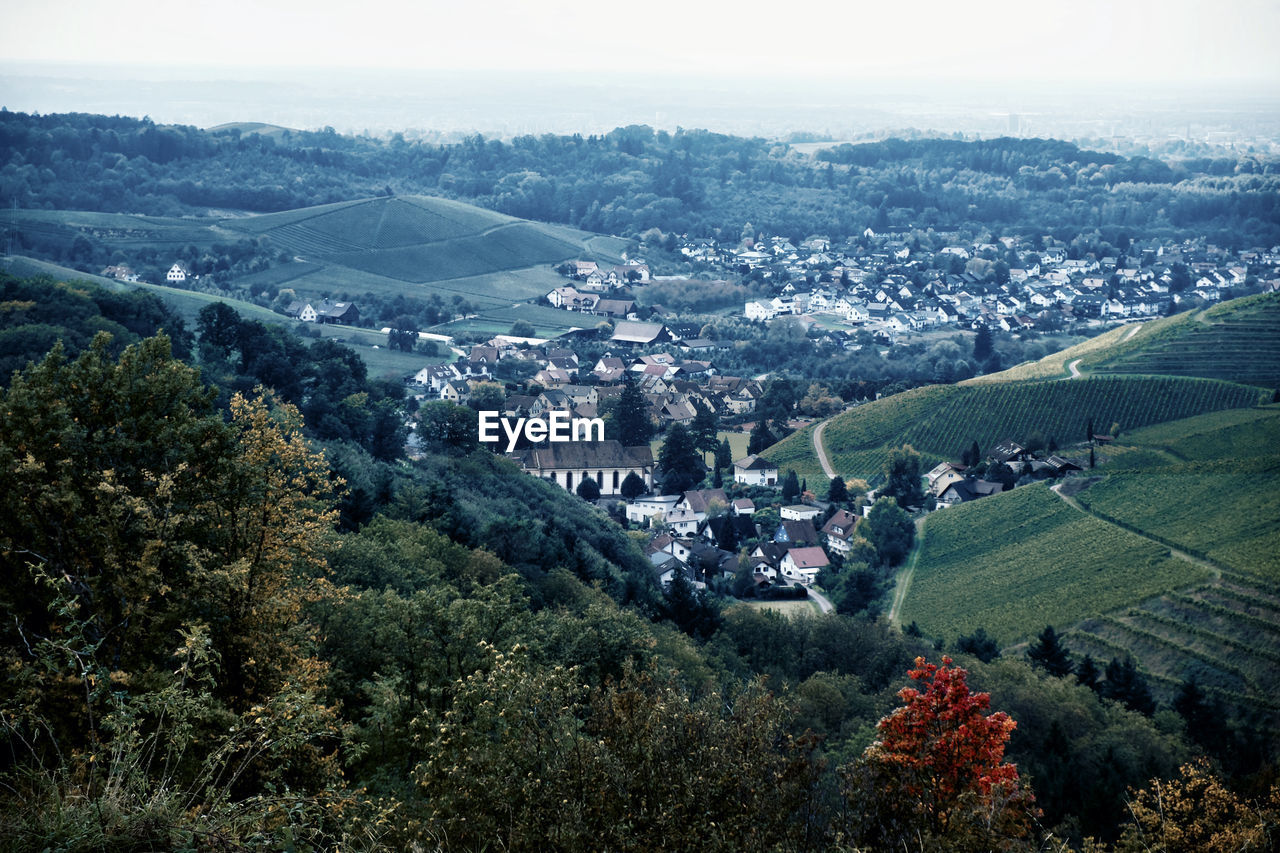 HIGH ANGLE VIEW OF TOWNSCAPE BY VILLAGE