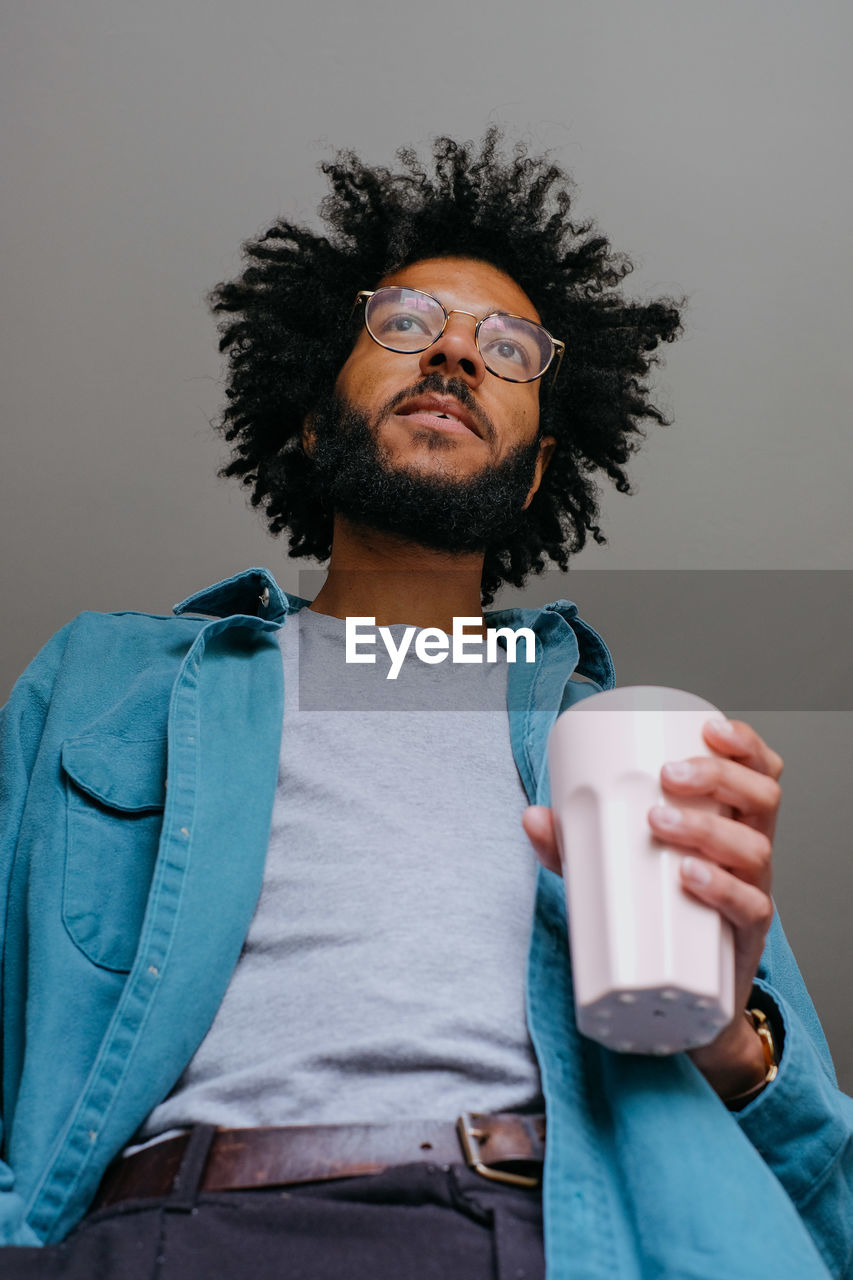 Low angle view of man holding coffee