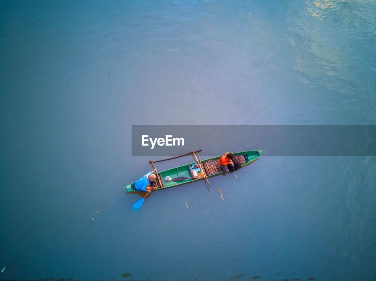 High angle view of fishermen in boat floating on sea