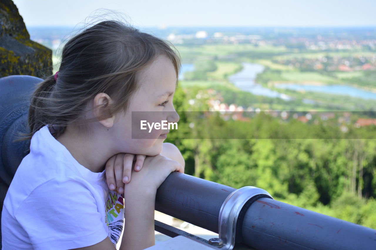 Close-up of girl looking at view of landscape