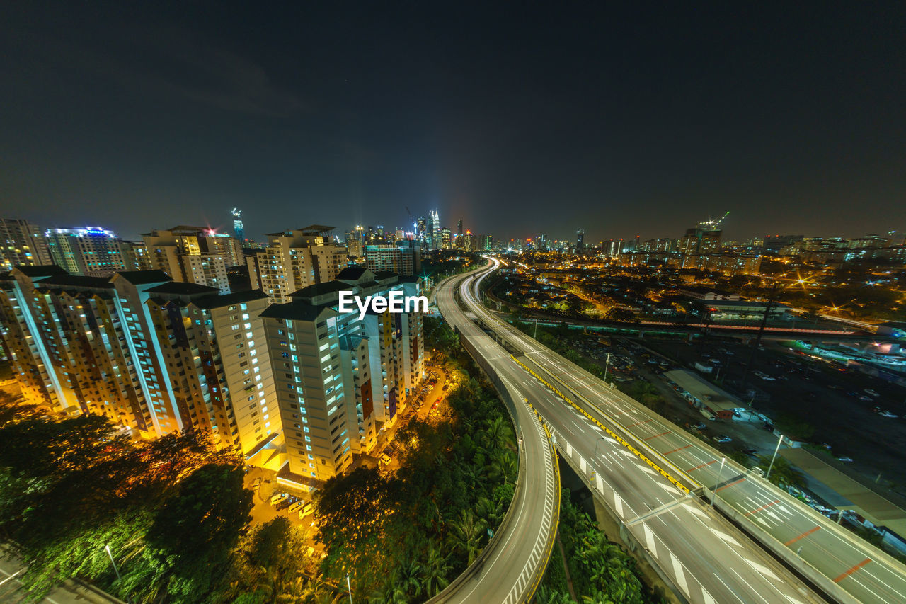 High angle view of light trails on road in city at night